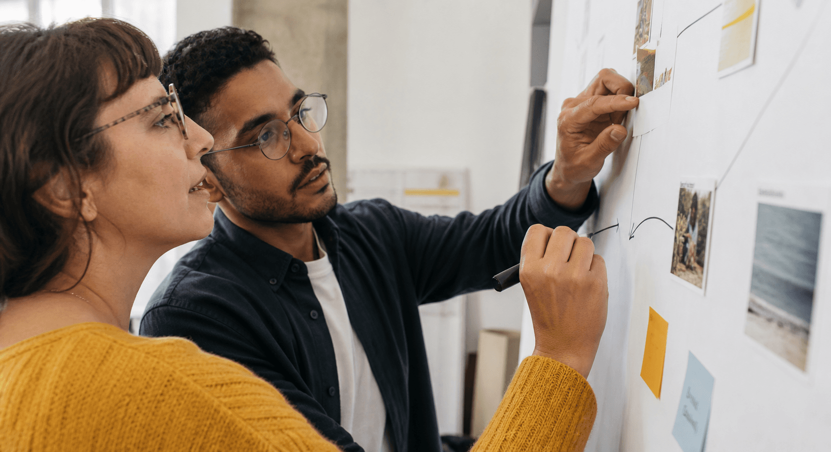 Two adult learners connecting evidence and ideas on a shared visual map